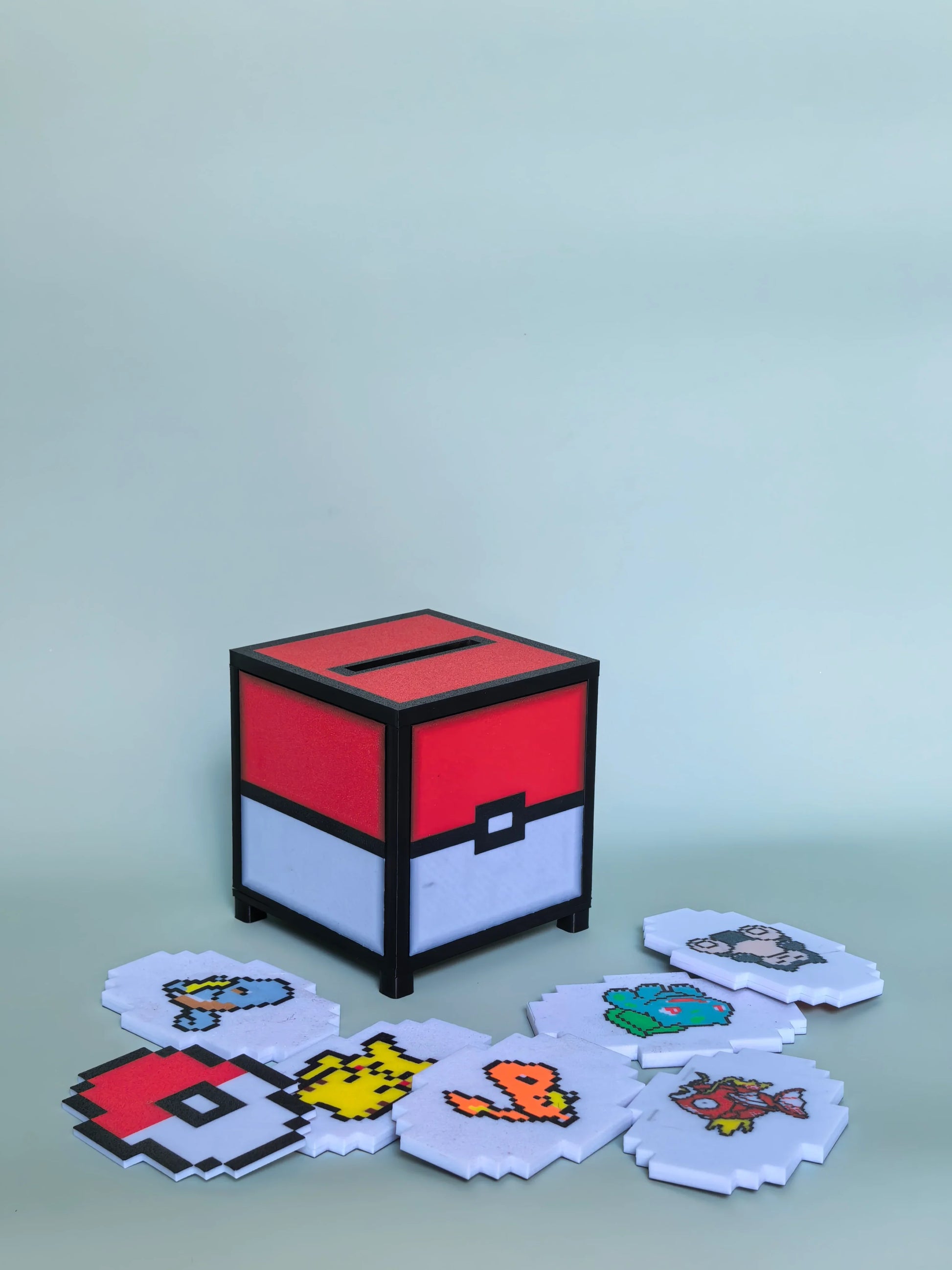 PixelJukebox adorned with iconic Pokemon motifs — lightning-yellow Pikachu accents, fiery Charmander tones, and Squirtle-blue waves across a compact NFC music player body.