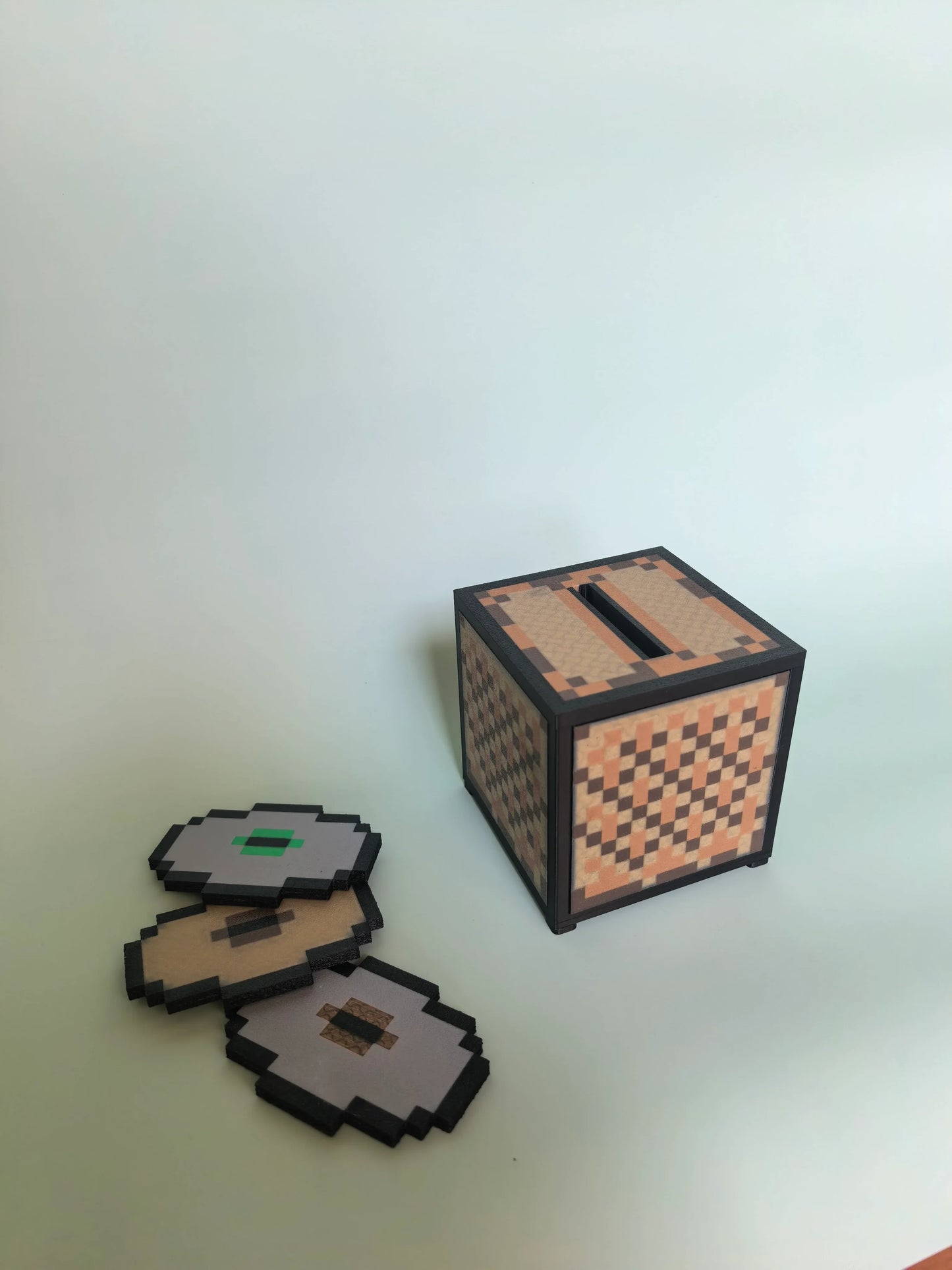 PixelJukebox adorned with iconic Minecraft motifs — grass-block textures, diamond-gem accents, and creeper-green highlights across a compact NFC music player body.