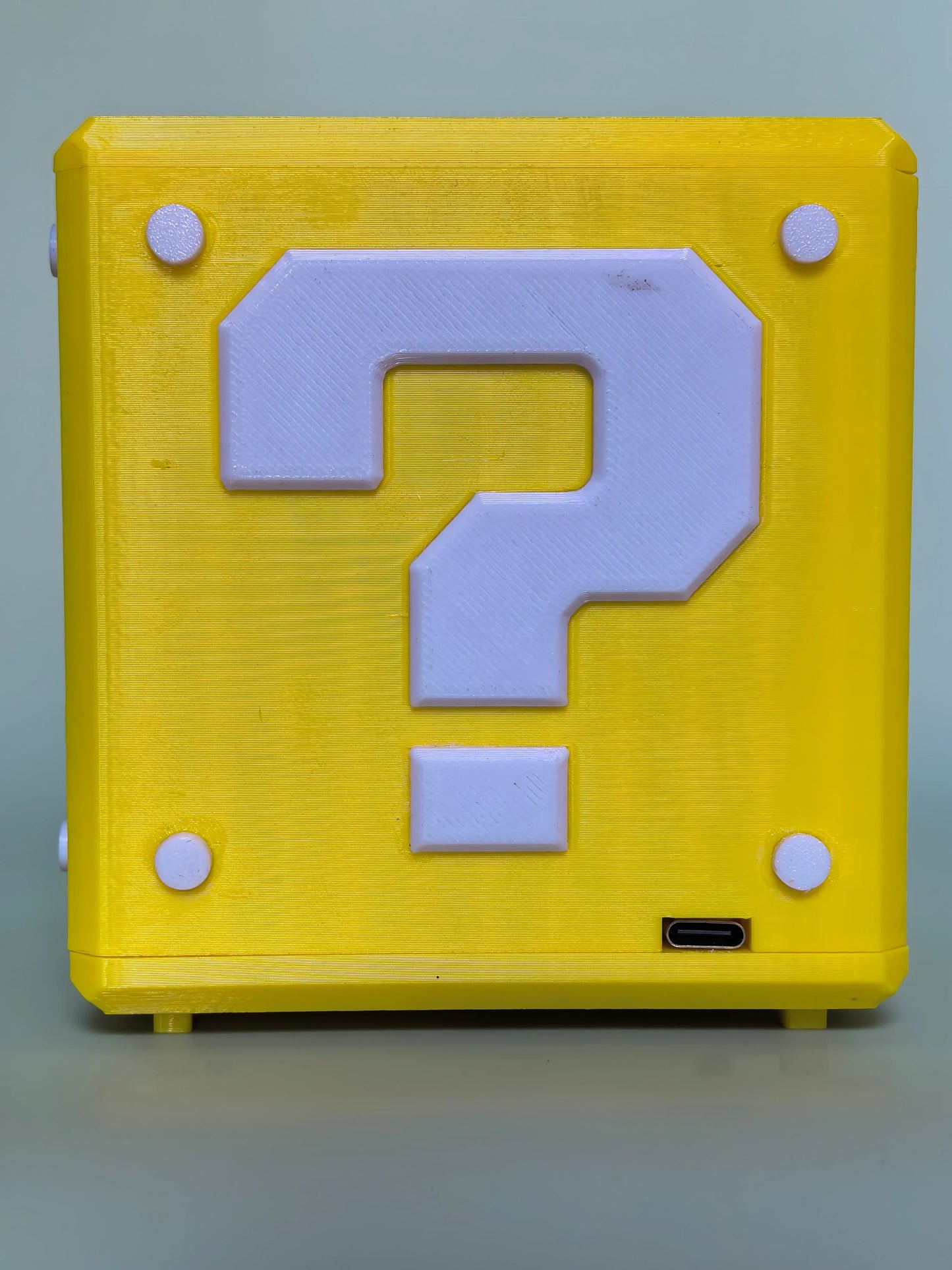 Close-up of PixelJukebox's pixel-perfect Mario-inspired design — blocky question-mark bricks, golden power-up coins, and red mushroom buttons crafted in authentic 8-bit pixel art style.